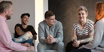 Teenagers laughing during a group counseling session