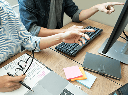 website developers working on a project on a shared screen