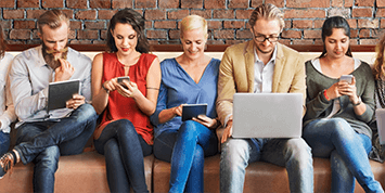 Diverse people browsing on digital devices