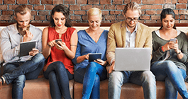 Diverse people browsing on digital devices