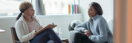 Therapist meets with her female client in her office