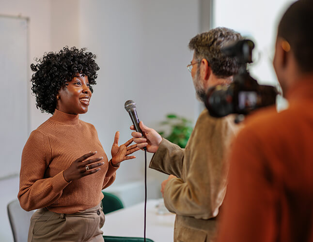 Woman being interviewed by a media crew interviewer