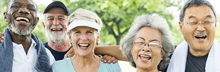 Close up of a group of senior people outside exercising and smiling