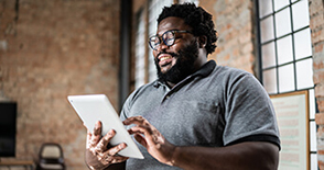 Man reading a newsletter on tablet