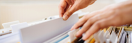 Person pulling a document from filing cabinet