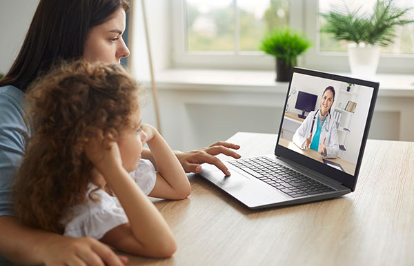 Mother and daughter in a telehealth session.