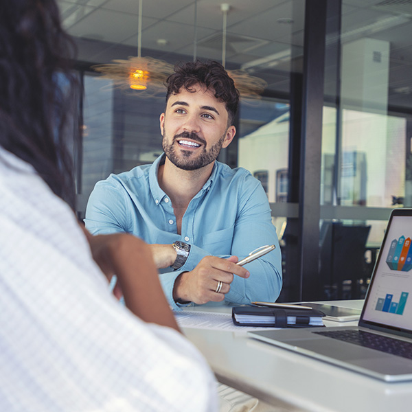 Smiling person sharing data and solutions with another